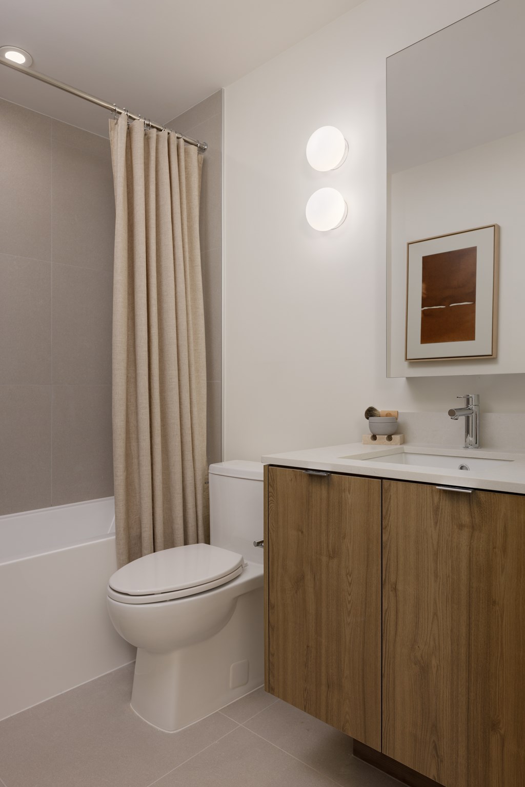 A bathroom with a toilet, sink, and shower curtain.