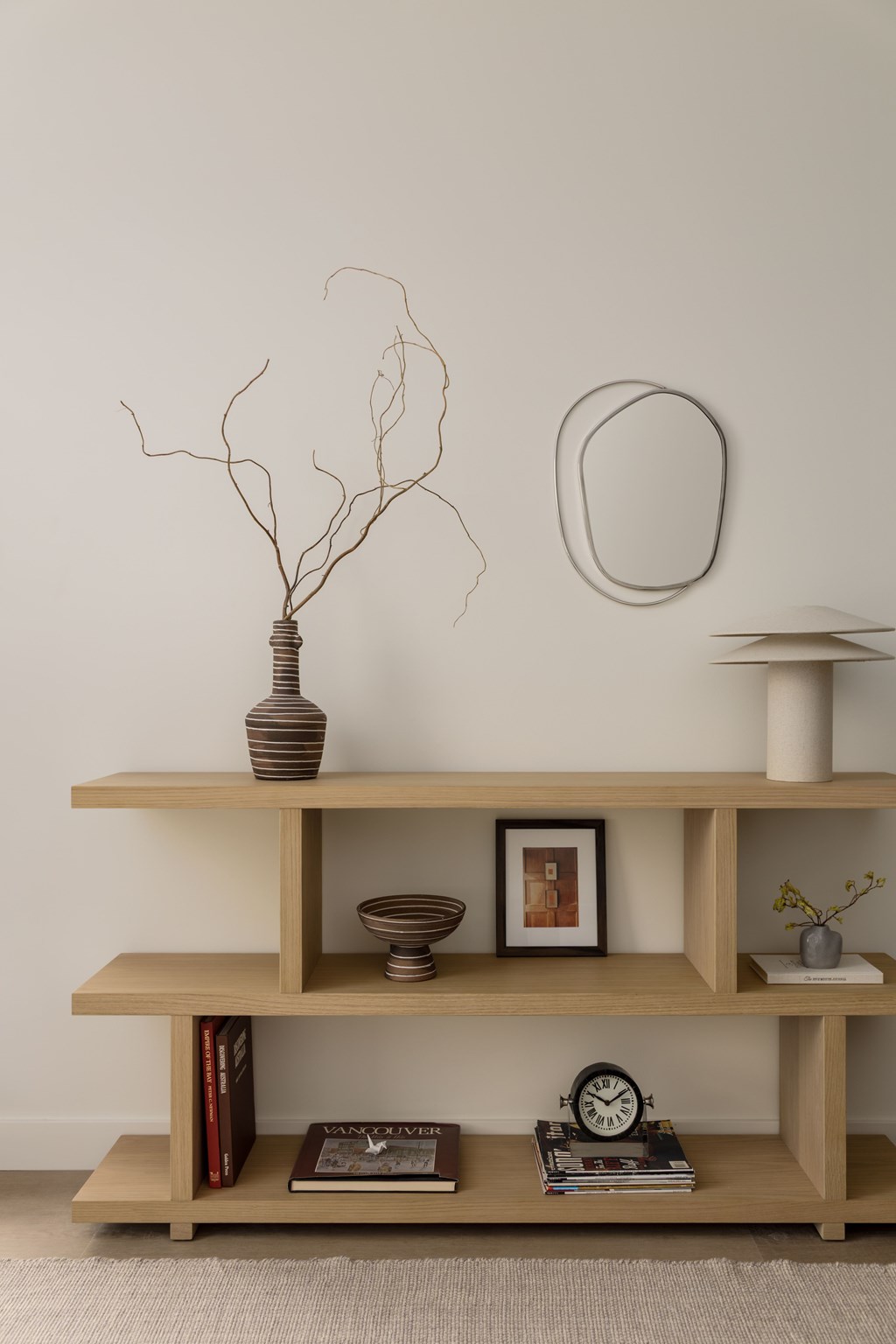 A wooden shelf with various decorative items on it.
