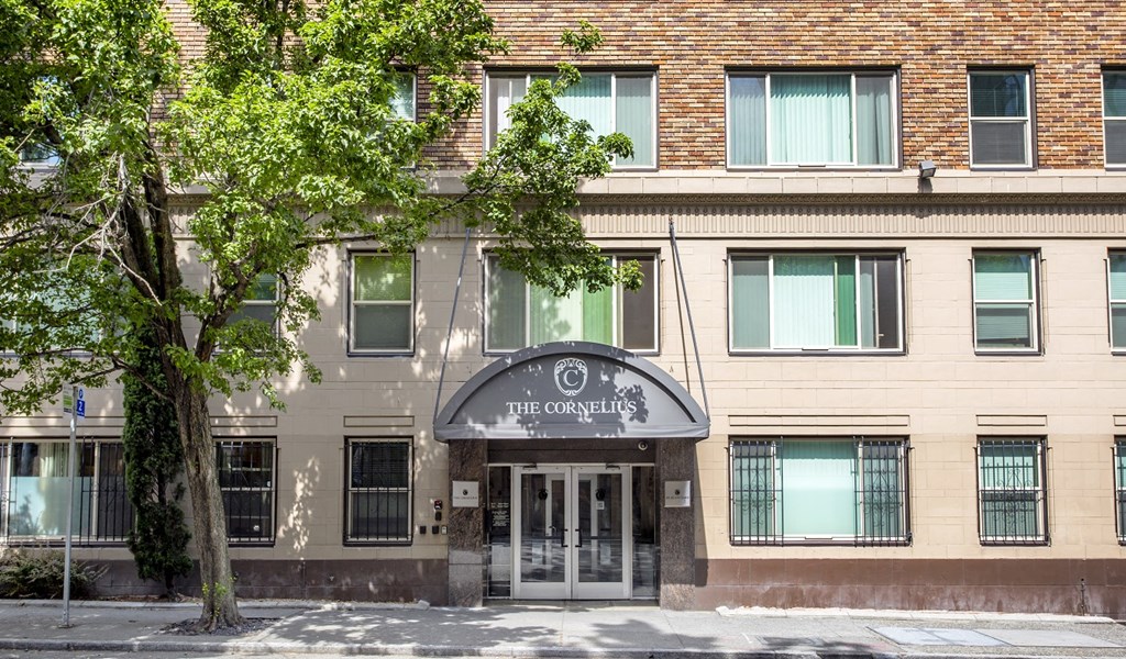 Building with a tree in front of it.