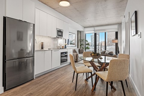 A modern kitchen with a glass table and chairs.