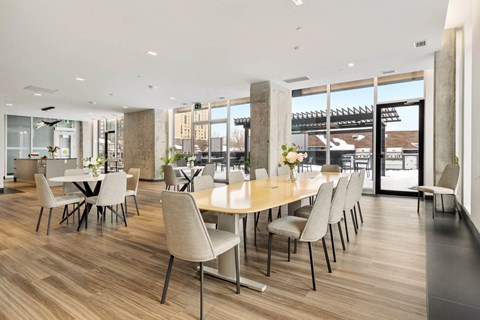A conference room with a long table and chairs.