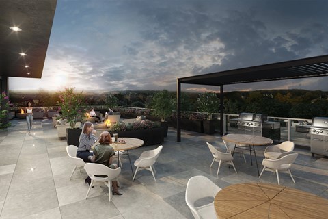 A modern outdoor dining area with people sitting around a table.