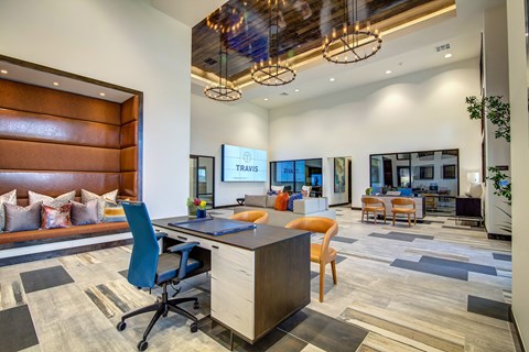 A modern office space with a reception area, desks, and chairs.