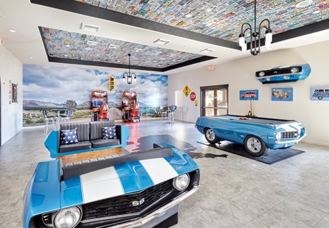 A blue and white striped car is parked in a room with a mosaic ceiling.