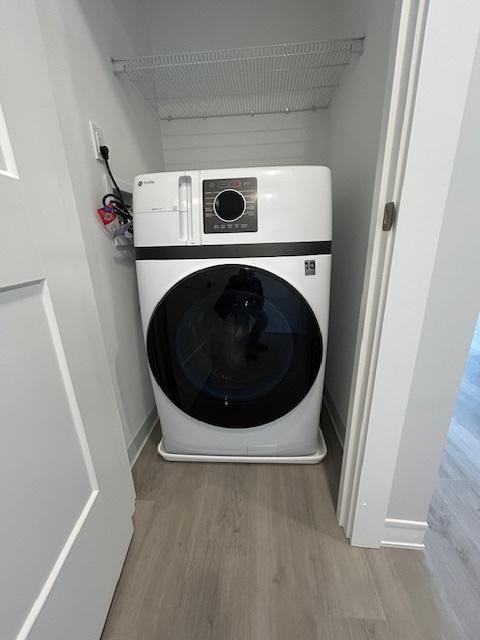 A white washing machine in a small laundry room.