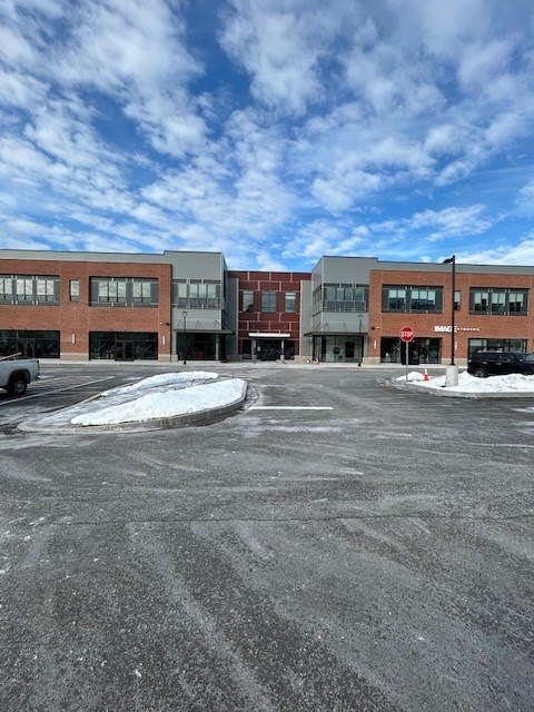 A parking lot with a building in the background.