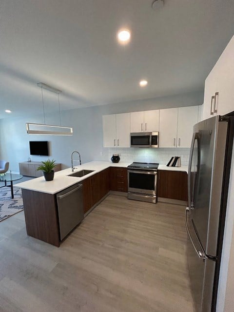 A modern kitchen with a refrigerator on the right side.