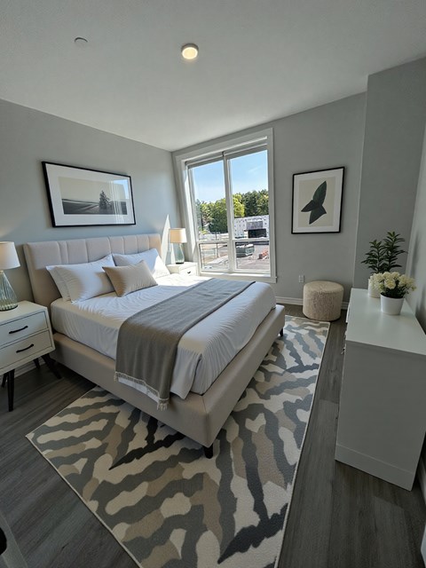 A bedroom with a large bed and a zebra print rug.