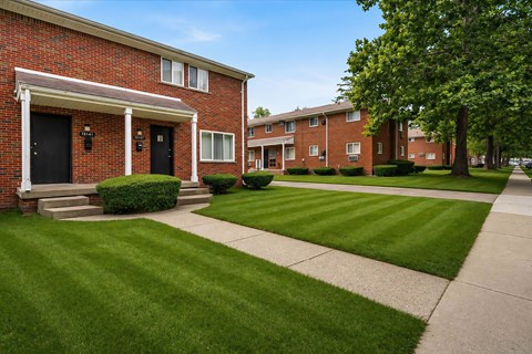 Brick apartment community with manicured lawns and sidewalks at Oak Park Gardens Apartments, Michigan, 48237