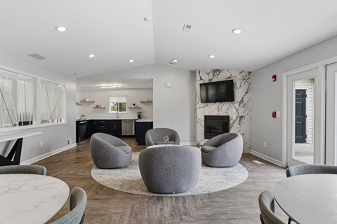 A modern living room with a fireplace and a TV mounted on the wall.