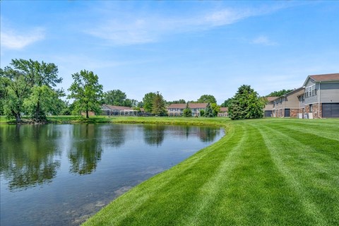 Pond view with surrounding landscaped grounds at South Grove Apartments, Ann Arbor, Michigan