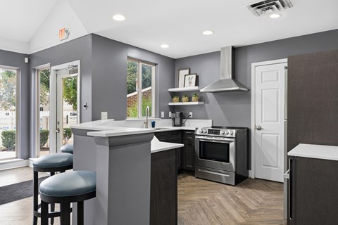 A modern kitchen with a white countertop and stainless steel appliances.