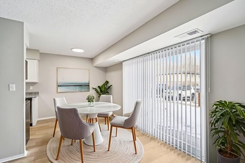 Dining area with modern furniture and vertical blinds at Cambridge on Ford Apartments, Canton, 48187