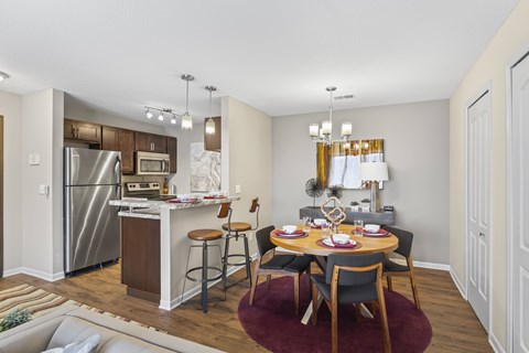 A kitchen with a dining table set for two.