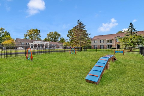 Dog park with agility equipment and fenced area at South Grove Apartments, Ann Arbor, Michigan