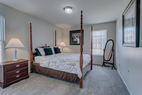 A bedroom with a four poster bed and a window.