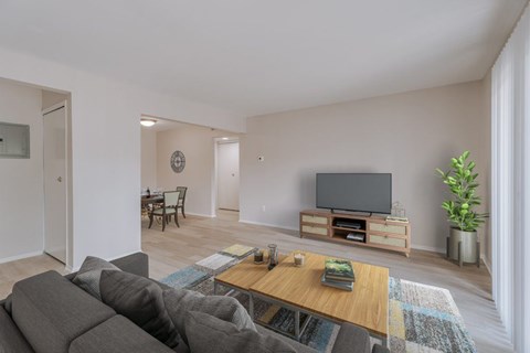 Modern living room with tv and dining area at Hidden Valley Apartments, Southfield, Michigan