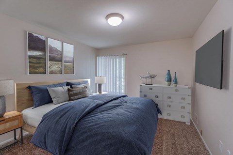 A bedroom with a large bed and a painting on the wall.