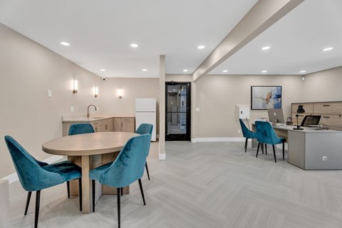 Community workspace with blue velvet chairs and kitchen at Hidden Valley Apartments, Southfield, MI