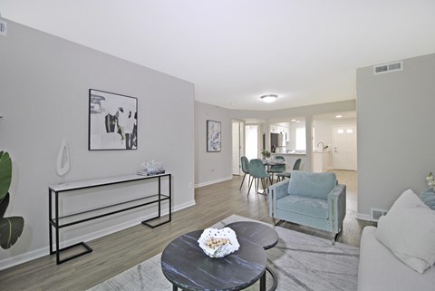 A living room with a couch, chairs, and a coffee table.