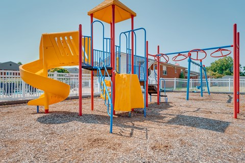Playground with spiral slide and monkey bars at Canterbury Square Apartments, Michigan, 48083