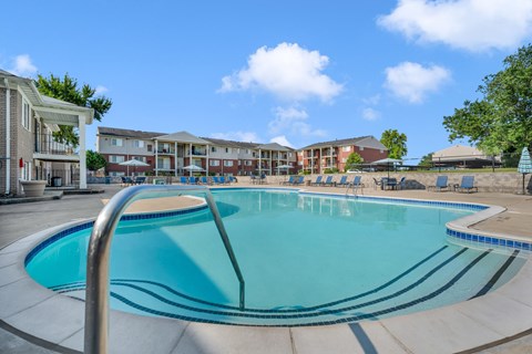 Resort style pool with sundeck and lounge seating at Cass Lake Shore Club Apartments, Michigan