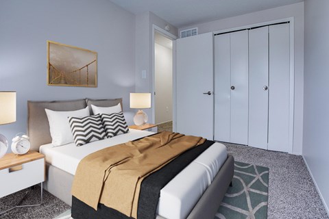 Bedroom with carpeted floors and sliding closet doors at Fordham Green Apartments, Canton, Michigan