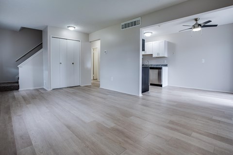 Open living area with kitchen and ceiling fan at Fordham Green Apartments, Canton, MI 48187