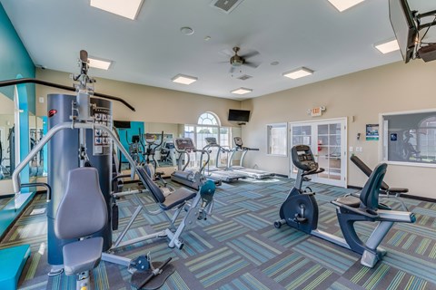 Fitness center with cardio and strength equipment at Kingsley Apartments, Sterling Heights