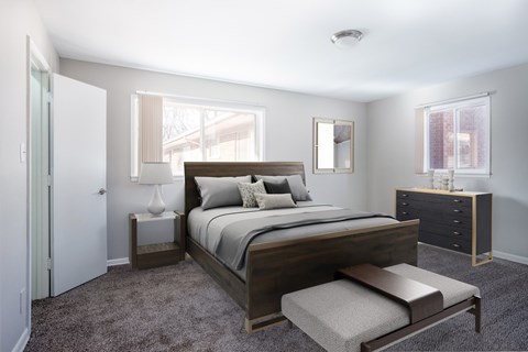 Master bedroom with wood furniture and large windows at Oak Park Gardens Apartments, Oak Park, 48237