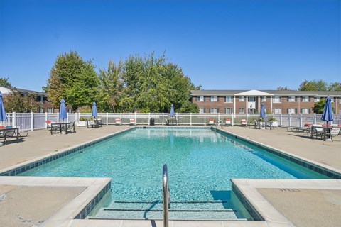Swimming pool with spa steps and patio furniture at Southpointe Square Apartments, Woodhaven, MI