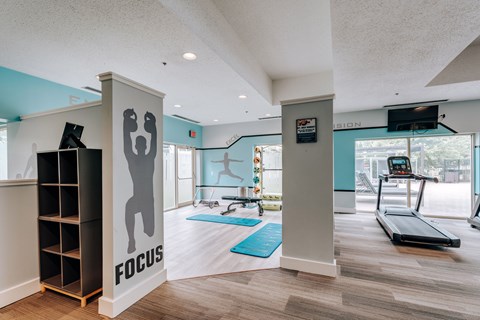 Fitness center with exercise equipment and yoga mats at Valley Ranch Apartments, Ann Arbor, MI