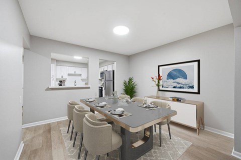 Modern dining room with gray table and kitchen passthrough at Glens of Bloomfield Apartments, Bloomfield Hills, MI 48301