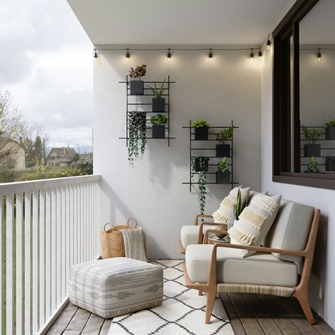 A balcony with a chair, ottoman, and wall-mounted planters.