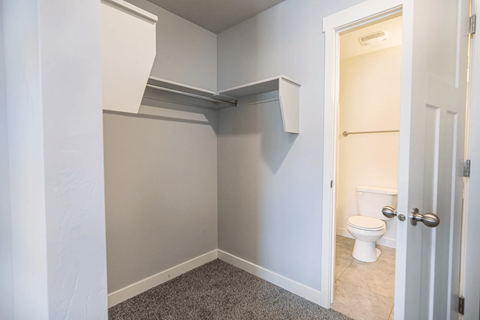 A small bathroom with a toilet and a cabinet above it.