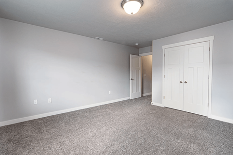 A room with a carpeted floor and white walls.
