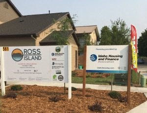 a couple of signs in front of a house