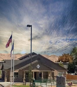 a house with two flags and a street light in front of it