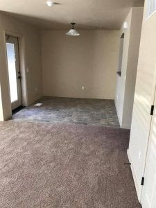 an empty room with a light hanging from the ceiling