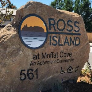 a large rock with a sign on it