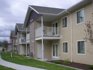 an apartment building with a balcony and a sidewalk