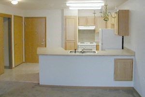 a kitchen with a white counter top and a white refrigerator