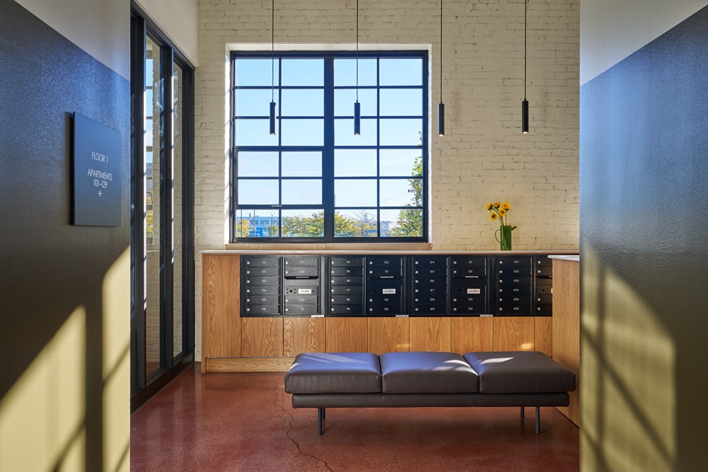 A room with a bench and a window.