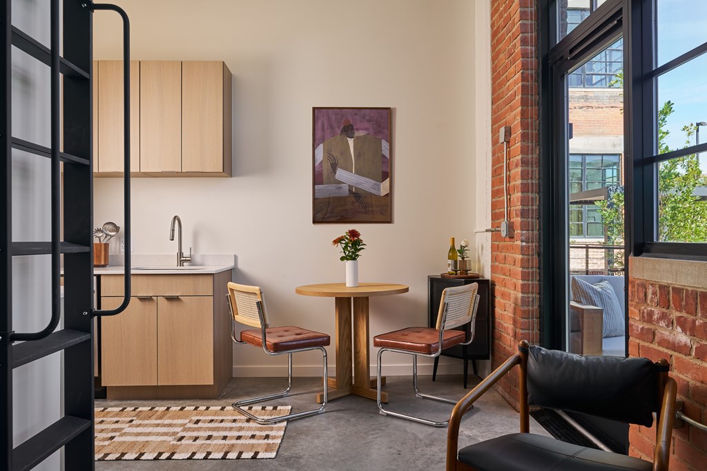 A modern kitchen with a table and chairs.
