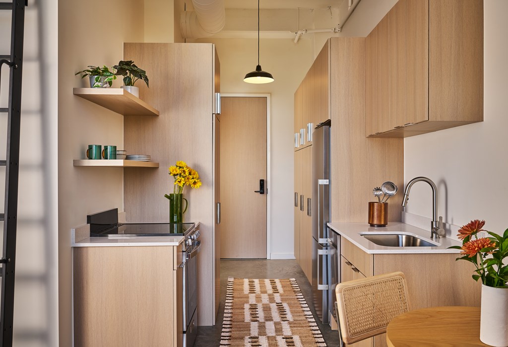 A kitchen with wooden cabinets and a refrigerator.