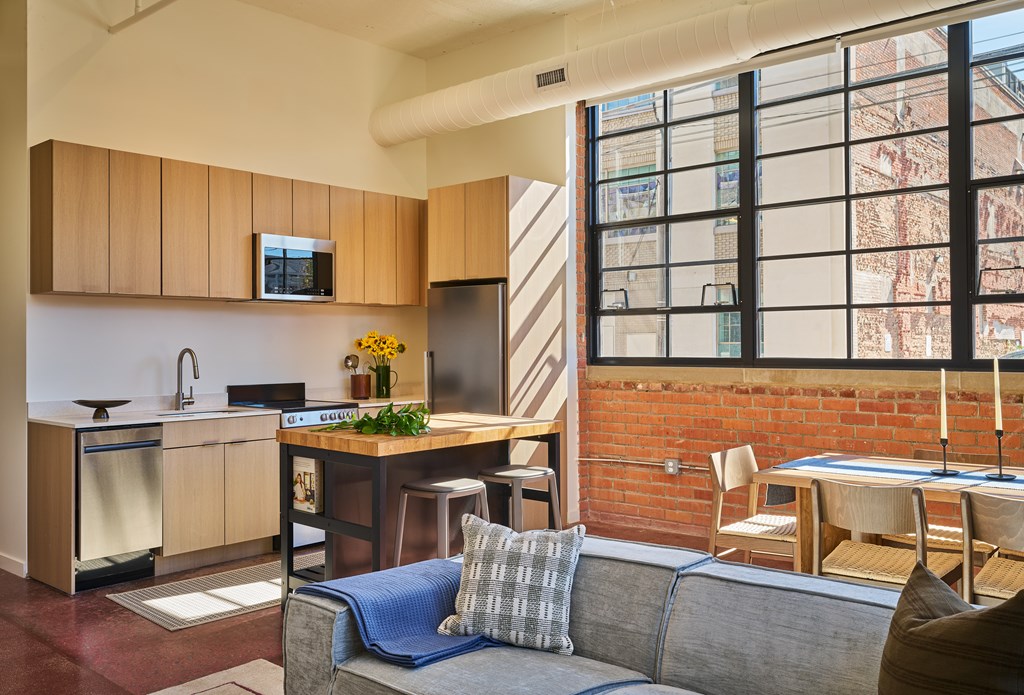 A kitchen with a dining table and chairs is shown.