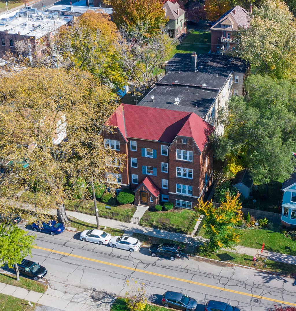 A red building with a green lawn in front of it.