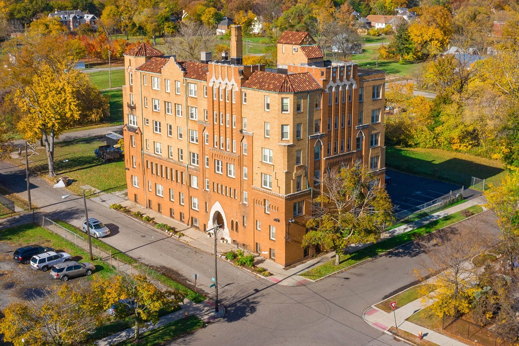 A large red brick building with a clock tower on the corner.