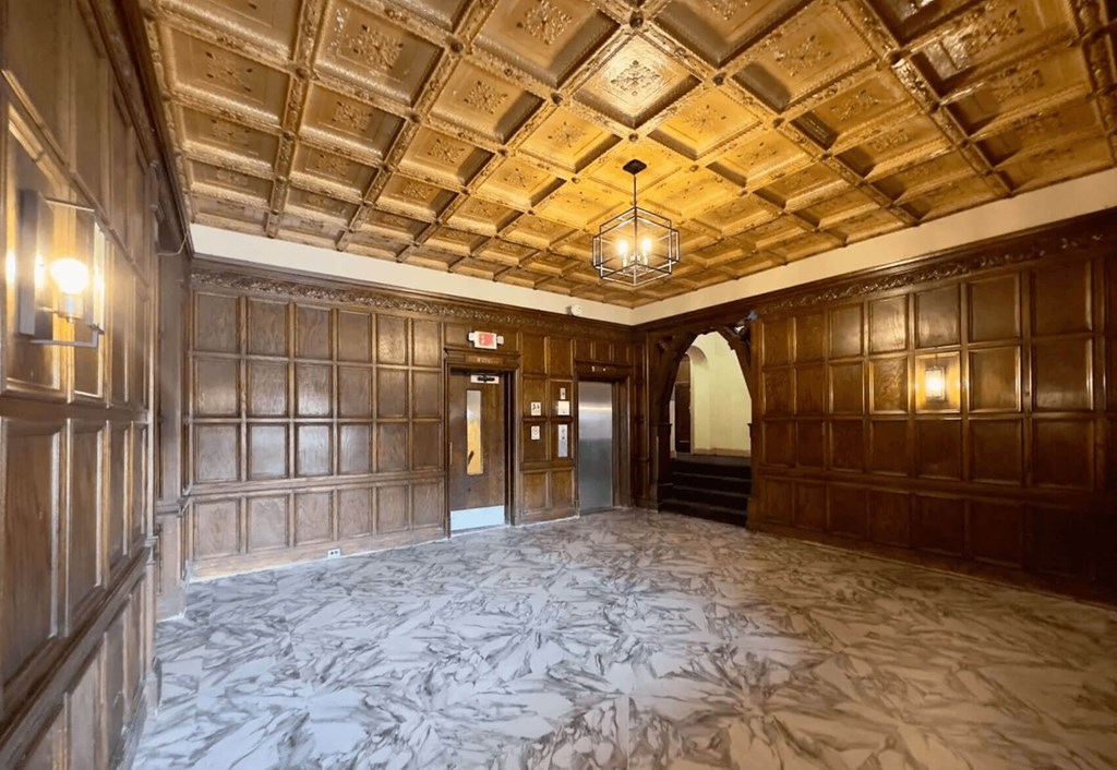 A large room with wooden walls and a marble floor.