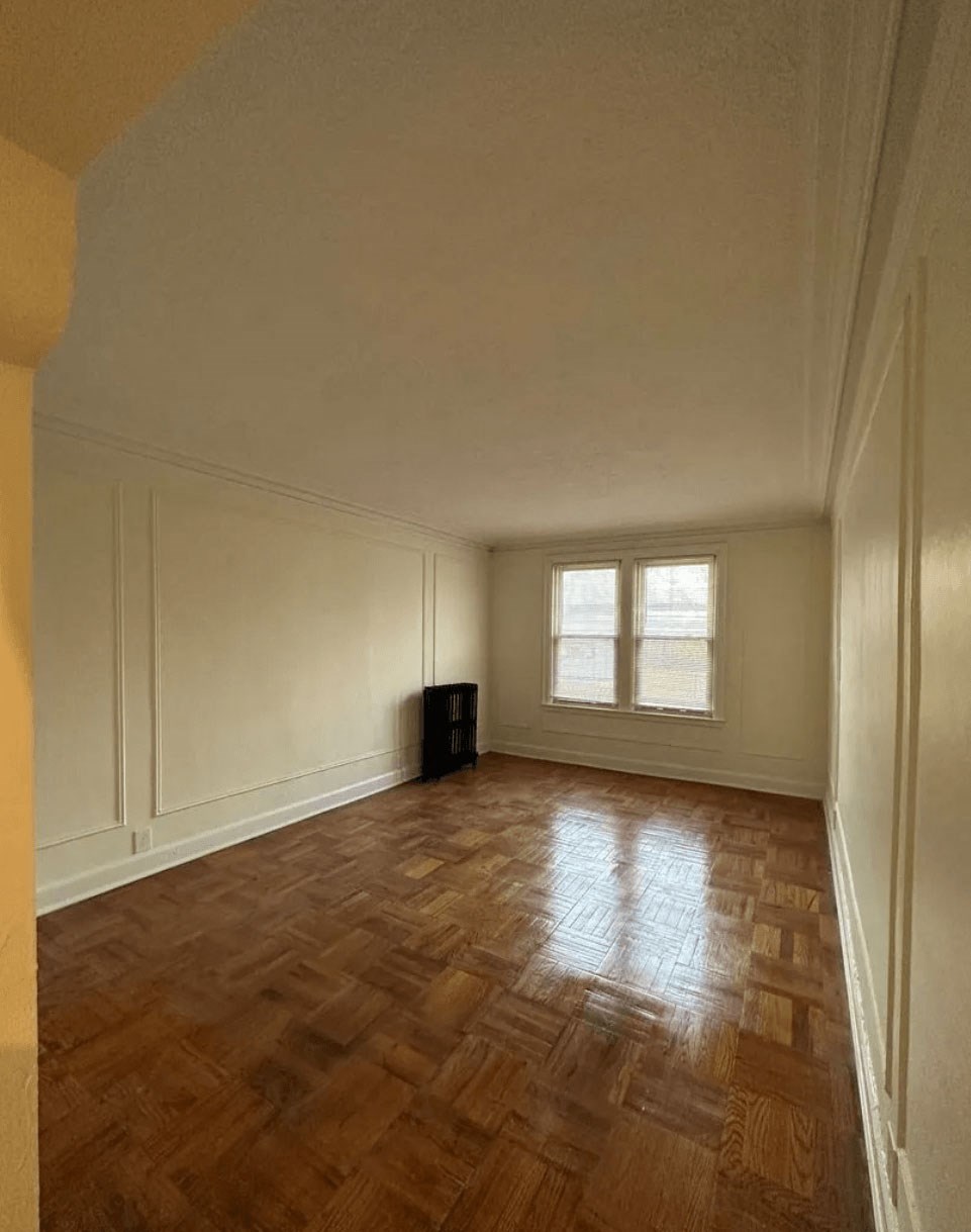 A room with wooden floors and a window.